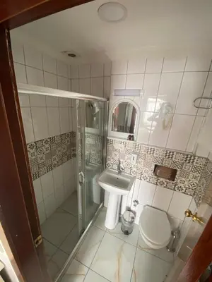 a bathroom with a sink and a shower and a toilet at Timex Suites in Istanbul
