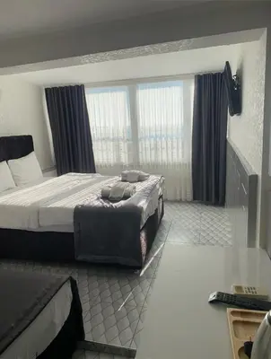 a hotel room with a bed and two windows at Timex Suites in Istanbul