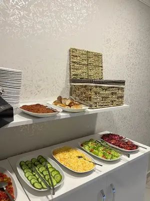 a buffet with plates of food on a shelf at Timex Suites in Istanbul