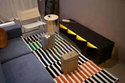 a living room with a striped rug on the floor at Design Apartment near the Bomonti in Istanbul