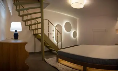 a bedroom with a bed and a spiral staircase at Design Apartment near the Bomonti in Istanbul