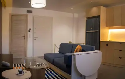 a living room with a blue couch and a table at Design Apartment near the Bomonti in Istanbul