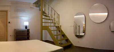 a room with a staircase and a mirror at Design Apartment near the Bomonti in Istanbul