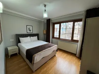 a bedroom with a large bed and a window at Gulhane Hotel Old City in Istanbul