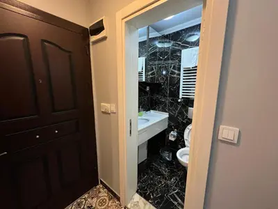 a bathroom with a sink and a toilet and a mirror at Gulhane Hotel Old City in Istanbul