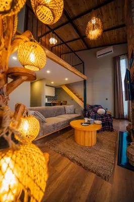 a living room with a couch and a table at Vital Göl Sapanca Özel Havuzlu Bungalov & Villa in Sapanca