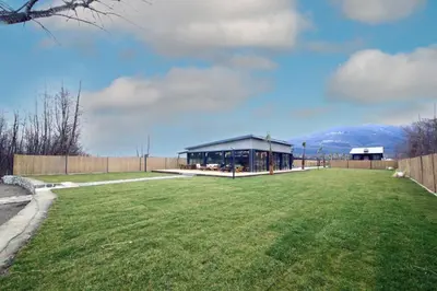 a large grass field with a building in the background at Vital Göl Sapanca Özel Havuzlu Bungalov & Villa in Sapanca