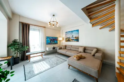 a living room with a couch and a table at Luxon Sapanca Family Villas in Sakarya
