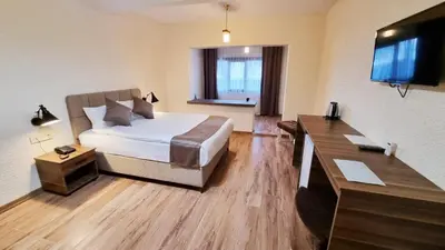 a hotel room with a bed and a flat screen tv at La Pearl Konaklama in Istanbul