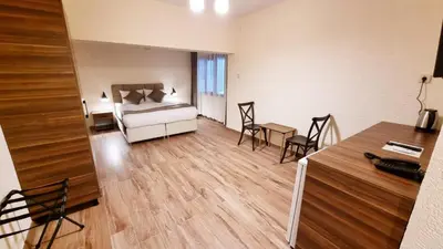 a bedroom with a bed and a table and chairs at La Pearl Konaklama in Istanbul