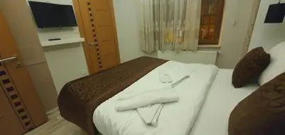 a bedroom with a bed with two towels on it at taksim k suites in Istanbul