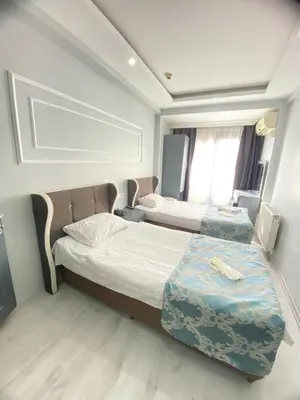 a bedroom with two beds and a window at Abam Hotel in Istanbul
