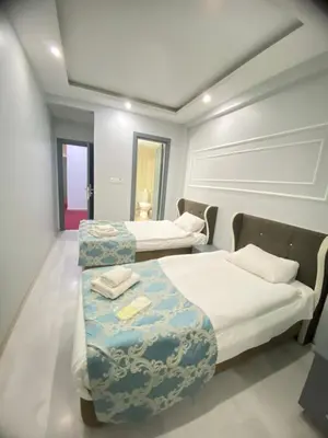 a hotel room with two beds and aception at Abam Hotel in Istanbul