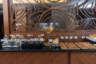 a counter with a bunch of pastries and a glass of wine at Anemon Bursa Otel in Bursa