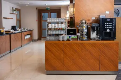 a coffee shop with a counter with a coffee maker at Anemon Bursa Otel in Bursa