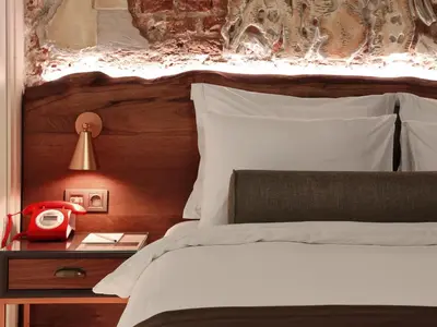 a bed with a red telephone on a night stand at Impera Hotel - Special Category in Istanbul
