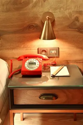 a red phone on a table next to a bed at Impera Hotel - Special Category in Istanbul