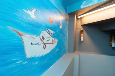 a wall with a painting of a boat in the water at Leyla palas in Istanbul