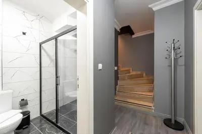 a bathroom with a shower and a toilet and stairs at Leyla palas in Istanbul