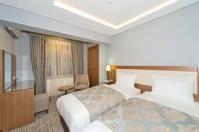 a hotel room with a bed and a desk at Floransa City Hotel in Istanbul