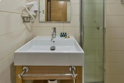 a bathroom with a white sink and a shower at Floransa City Hotel in Istanbul
