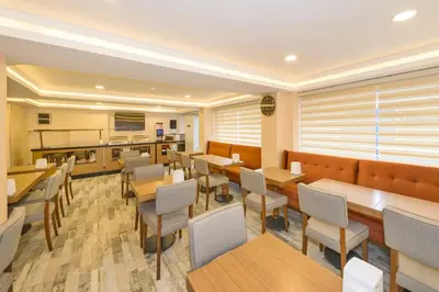 a restaurant with tables and chairs and a kitchen at Floransa City Hotel in Istanbul