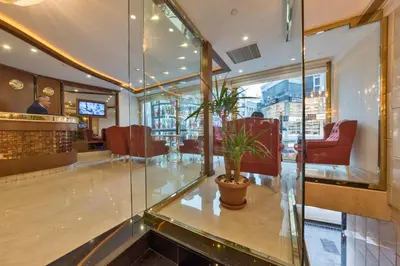 a lobby of a restaurant with a potted plant at Marcello Hotel in Istanbul