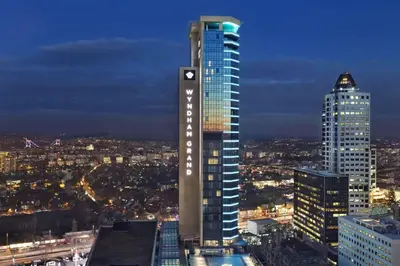 a tall building in a city at night at Wyndham Grand Istanbul Levent Hotel & Conference Center in Istanbul