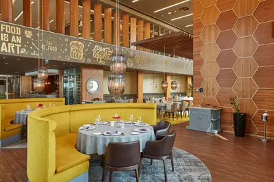 a dining room with a table and chairs in a restaurant at Wyndham Grand Istanbul Levent Hotel & Conference Center in Istanbul