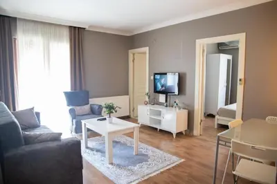 a living room with a couch and a tv at The Hera Hotels in Istanbul