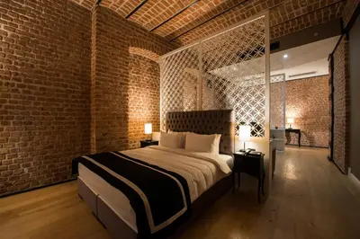 a bedroom with a bed and a brick wall at Régie Ottoman Istanbul - Special Category in Istanbul