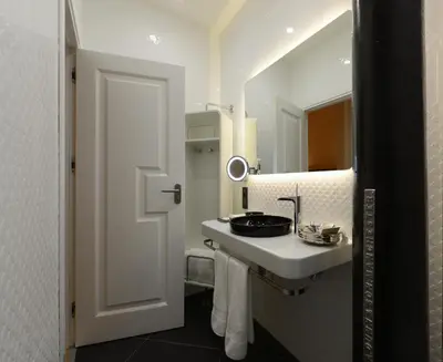 a white bathroom with a sink and a mirror at Régie Ottoman Istanbul - Special Category in Istanbul
