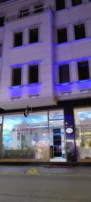 a store front with blue lights in front of a building at Raimond Hotel in Istanbul