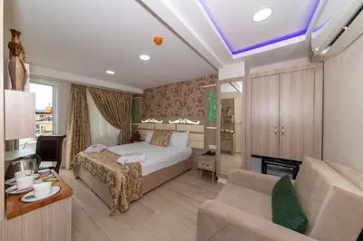 a bedroom with a bed and a living room at Raimond Hotel in Istanbul