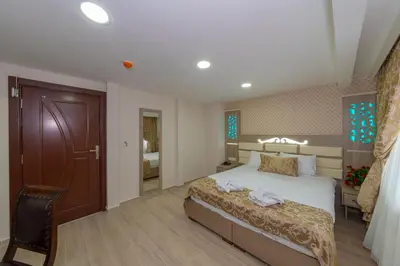 a hotel room with a bed and a chair at Raimond Hotel in Istanbul