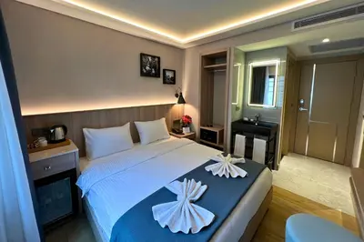 a bedroom with a bed with two white flowers on it at Woxx Hotel in Istanbul