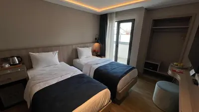a hotel room with two beds and a window at Woxx Hotel in Istanbul