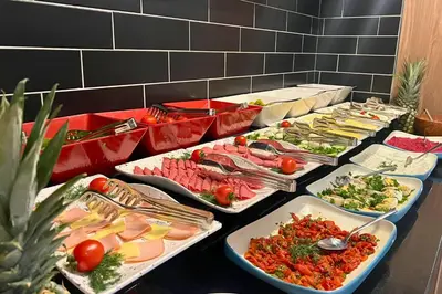 a buffet with many trays of food on a table at Woxx Hotel in Istanbul