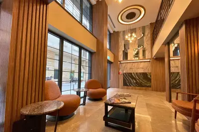 a lobby with chairs and tables in a building at Woxx Hotel in Istanbul