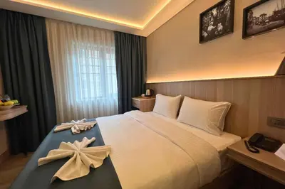 a hotel room with a bed with a bow on it at Woxx Hotel in Istanbul
