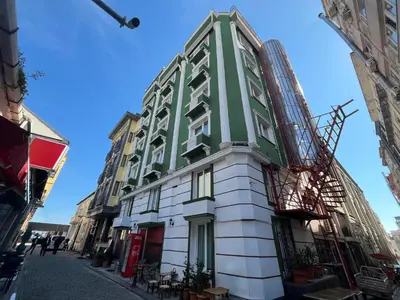 a green and white building on a street at Le Safran in Istanbul