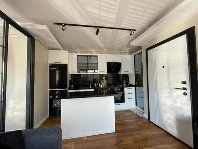 a kitchen with white cabinets and a white counter top at ARC HOUSE in Istanbul