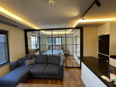 a living room with a couch and a bedroom at ARC HOUSE in Istanbul