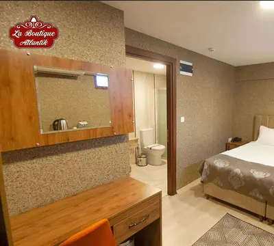 a hotel room with a bed and a mirror at Atlantik Butik Hotel in Tekirdag