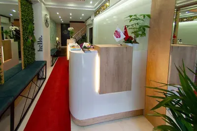 a lobby with a red carpet and a counter with flowers at Atlantik Butik Hotel in Tekirdag