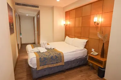 a hotel room with a bed with towels on it at Cumbali Plaza Hotel in Istanbul