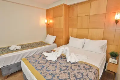 a hotel room with two beds with towels on them at Cumbali Plaza Hotel in Istanbul
