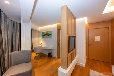a bathroom with a sink and a tv in a room at Baver Hotel in Istanbul