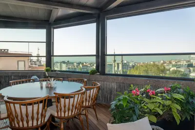 a patio with a table and chairs and windows at Baver Hotel in Istanbul