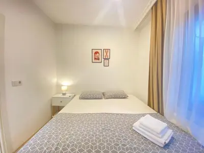 a white bedroom with a bed and a window at Historical comfy flat in Beyoğlu tophane, galata in Istanbul